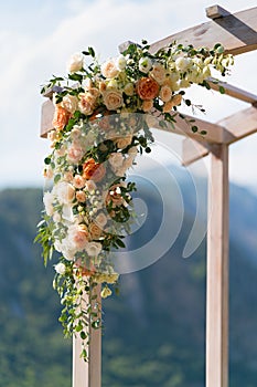 Beautiful wooden wedding arch decorated with flowers