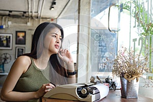 Beautiful writer looking out window,