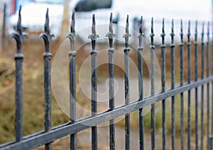 Beautiful wrought fence. Image of a decorative cast iron fence. metal fence close up. Metal Forged Fence.