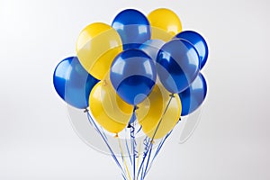 Beautiful yellow and blue party balloon floating gracefully on a pristine white background