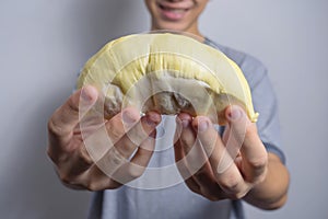 Beautiful yellow durian, ready to eat in the hands of Asian men who like to eat a lot of durians. Thais like to eat durian that is