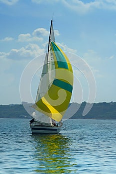 Beautiful yellow sail in the light-blue sky