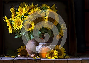 beautiful yellow Sunflower still life bouquet in a clay jug ceramic rustic style oil honey Dark photo background wooden table