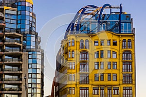 Beautiful yellow vintage building with another building that has a lot of glass windows, City architecture of Blankenberge,