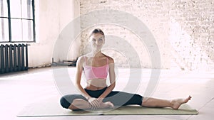 Beautiful yoga girl doing asanas in studio