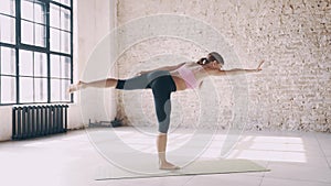 Beautiful yoga girl doing asanas in studio