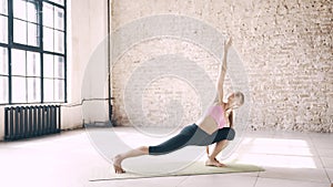 Beautiful yoga girl doing asanas in studio