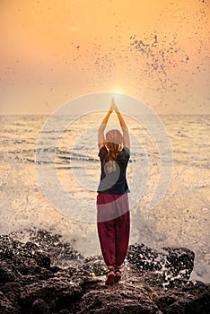 Beautiful yoga meditation reflection on water Goa beach on sunset