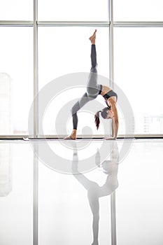 Beautiful yoga woman practice in a training hall background. Yoga concept.