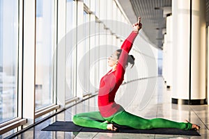 Beautiful yoga woman practice yoga poses on grey background.