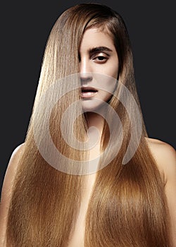 Beautiful yong woman with long Straight brown Hair. fashion model with smooth gloss hairstyle. Keratin Treatment