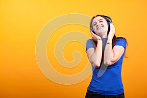 Beautiful youg woman listening music with her headphones