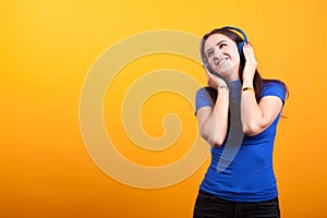 Beautiful youg woman listening music with her headphones