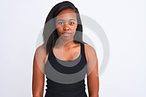 Beautiful young african american woman over isolated background with serious expression on face