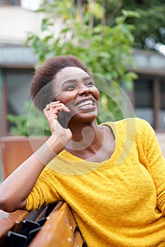 Beautiful young african american woman talking on cellphone outdoors