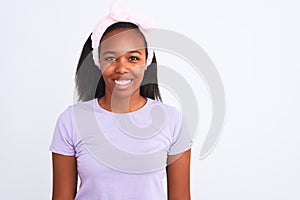 Beautiful young african american woman wearing a beauty diadem over isolated background with a happy face standing and smiling