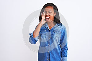 Beautiful young african american woman wearing denim jacket over isolated background shouting and screaming loud to side with hand