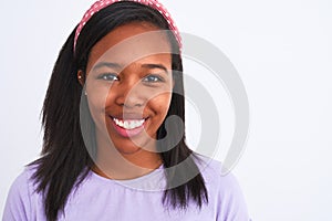 Beautiful young african american woman wearing a diadem over isolated background with a happy face standing and smiling with a