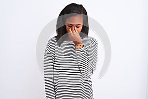 Beautiful young african american woman wearing winter sweater over isolated background tired rubbing nose and eyes feeling fatigue