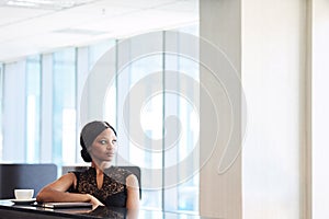 Beautiful young african woman looking thoughtfully off into the distance