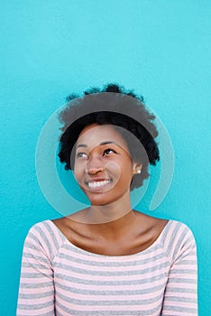 Beautiful young african woman smiling with a glance photo
