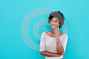 Beautiful young african woman smiling and thinking