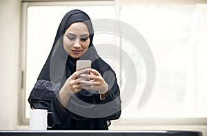 Beautiful young arabian woman texting