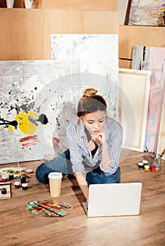 beautiful young artist using laptop