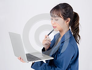 Beautiful young asian business woman happy holding credit card and laptop computer with payment shopping online