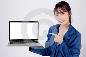 Beautiful young asian business woman happy holding and presenting laptop computer blank screen isolated