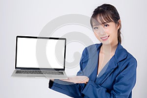 Beautiful young asian business woman happy holding and presenting laptop computer blank screen isolated on white background