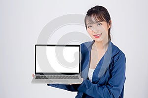 Beautiful young asian business woman happy holding and presenting laptop computer blank screen isolated on white background