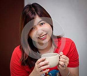 Beautiful Young Asian - Chinese Woman Holding Cup