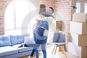 Beautiful young asian couple hugging in love, smiling happy and very excited for moving to a new home