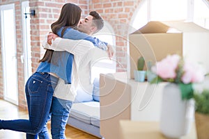 Beautiful young asian couple hugging in love, smiling happy and very excited for moving to a new home