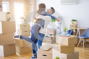 Beautiful young asian couple hugging in love, smiling happy and very excited for moving to a new home