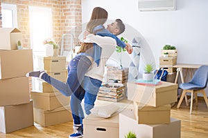 Beautiful young asian couple hugging in love, smiling happy and very excited for moving to a new home