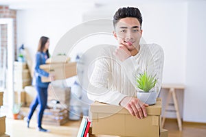 Beautiful young asian couple looking happy, handsome man smiling excited moving to a new home