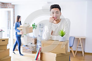 Beautiful young asian couple looking happy, handsome man smiling excited moving to a new home