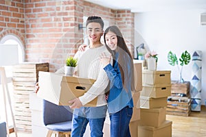 Beautiful young asian couple looking happy and smiling excited moving to a new home