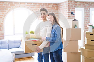 Beautiful young asian couple looking happy and smiling excited moving to a new home
