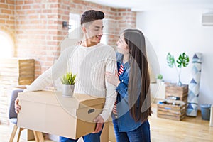 Beautiful young asian couple looking happy and smiling excited moving to a new home