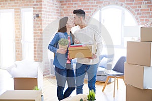 Beautiful young asian couple looking happy and smiling excited moving to a new home