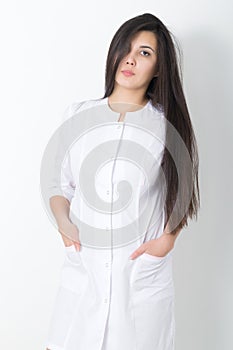 Beautiful young asian female doctor in medical gown holding a phonendoscope