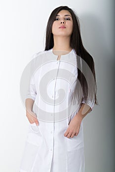 Beautiful young asian female doctor in medical gown holding a phonendoscope