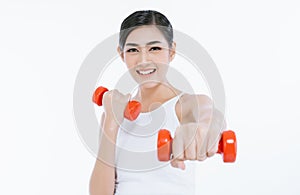 Beautiful young Asian fitness woman lifting dumbbells smiling and energetic isolated over white background. Healthy lifestyle