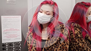 Beautiful young asian girl colored hair check medical mask in mirror