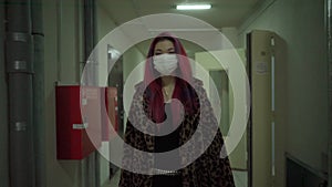 Beautiful young asian girl in medical mask clothing walk gloomy dark corridor