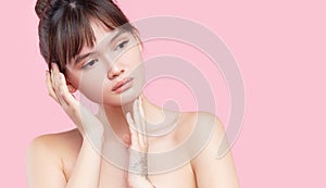 Beautiful young asian korean woman with clean fresh skin touching her own face. Face treatment.