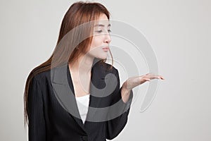 Beautiful young Asian woman blow a kiss.